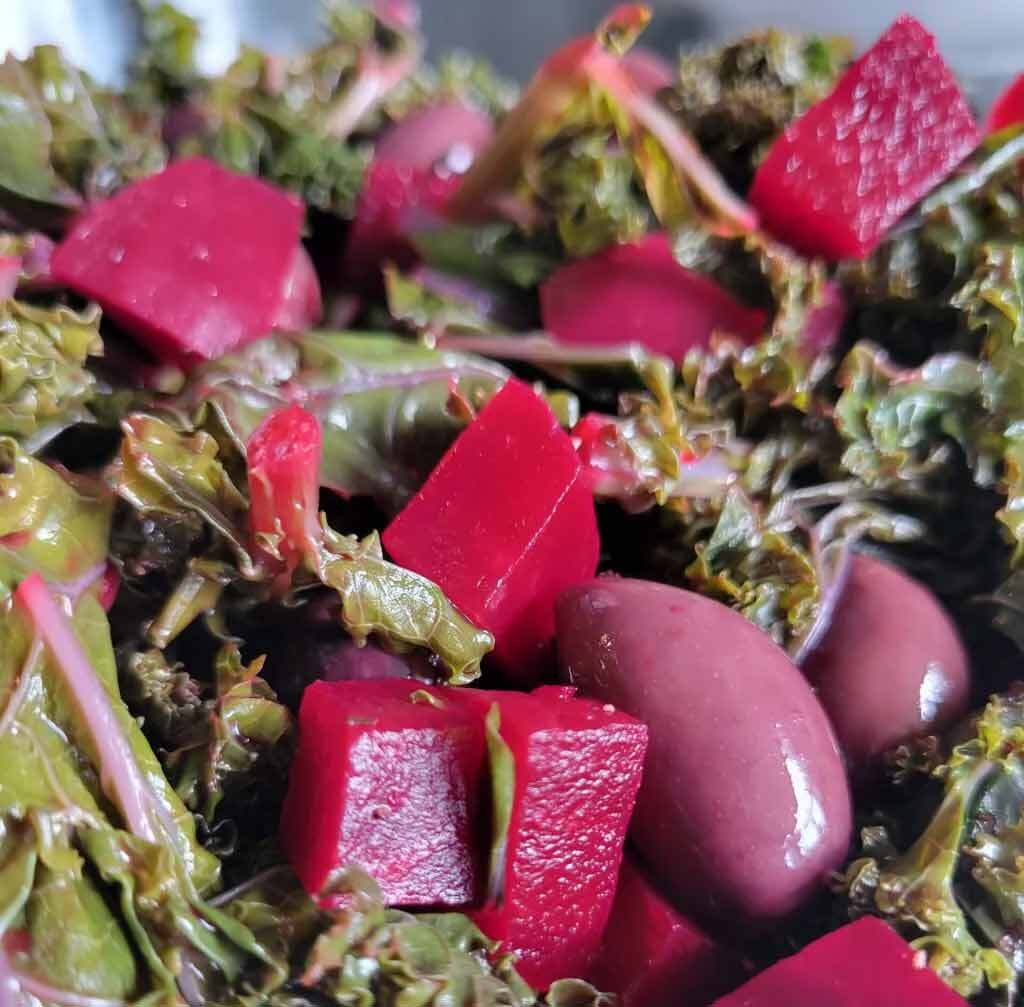 A cooking blog about a Greek-style green salad made with steamed red kale and red beets.
