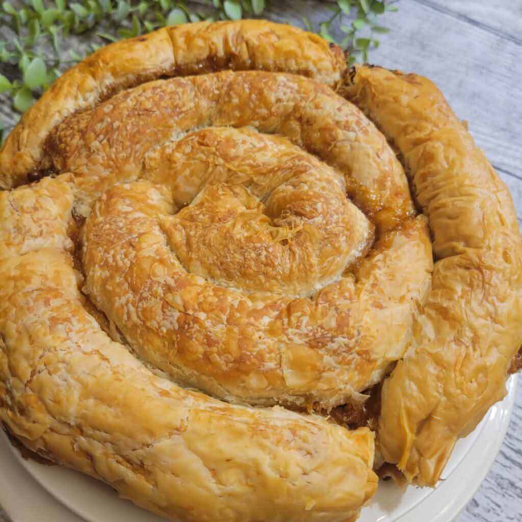 A food blog about Greek Sweet Pumpkin Pie made with cinnamon, pumpkin, vanilla, and caramel extracts, a little salt, date sugar, and honey.
