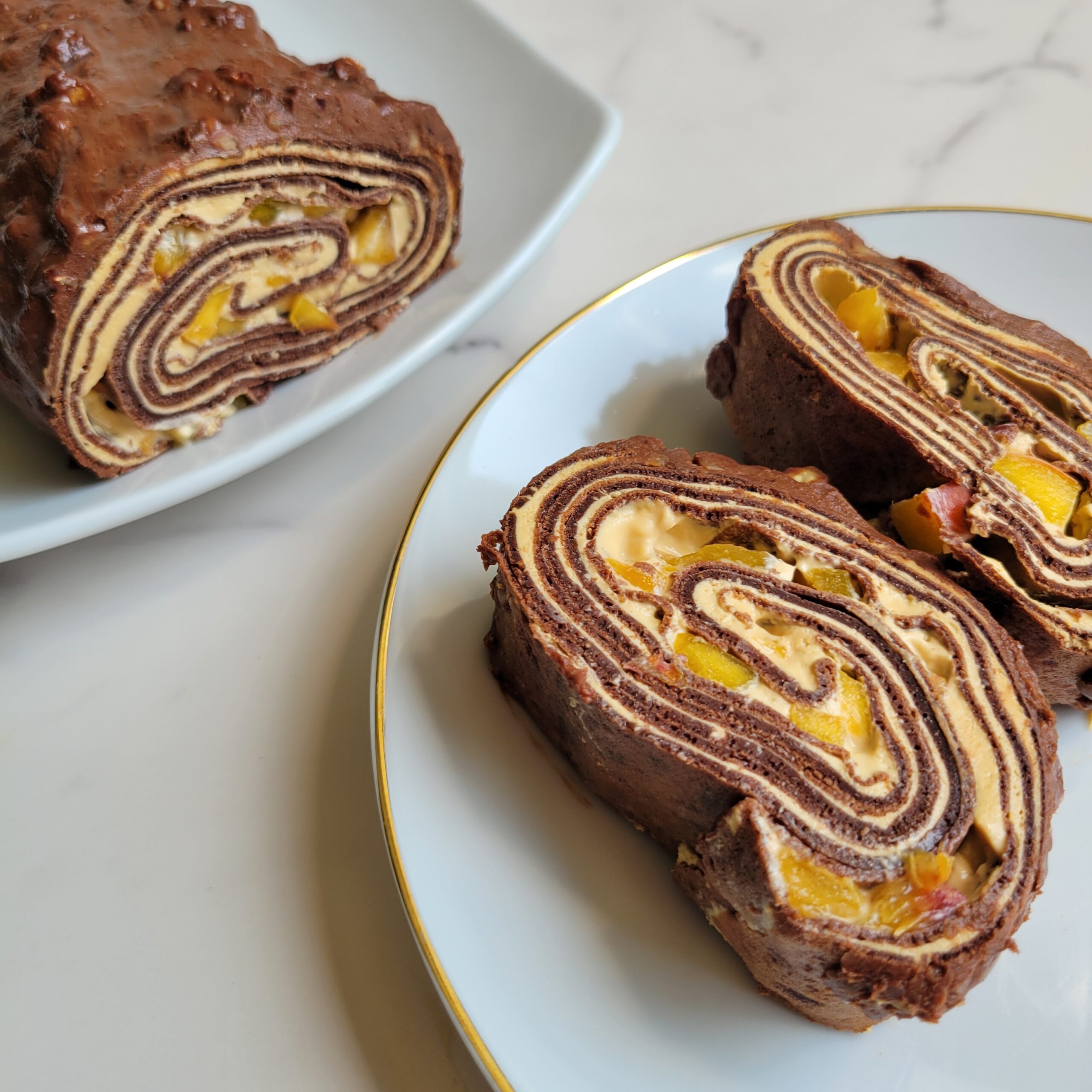 Read more about the article Chocolate Crepe Roll Cake (French Mille Cake) with Dulce de Leche Filling, Peaches, and Hazelnuts